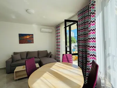 a living room with a table and a couch at HORIZON 12 'Б' Apartment Sveti Vlas in Sveti Vlas