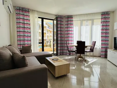 a living room with a couch and a table at HORIZON 12 'Б' Apartment Sveti Vlas in Sveti Vlas