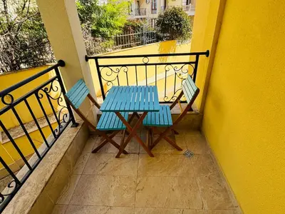 a blue table and two chairs on a balcony at HORIZON 10 'Б' Apartment Sveti Vlas in Sveti Vlas