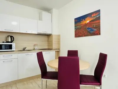 a kitchen with a table and chairs and a microwave at HORIZON 9 'Б' Apartment Sveti Vlas in Sveti Vlas