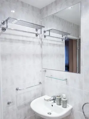 a white bathroom with a sink and a mirror at YES Varna Studios in Varna City