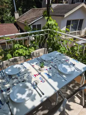 a blue table with plates and silverware on a patio at YES Varna Studios in Varna City
