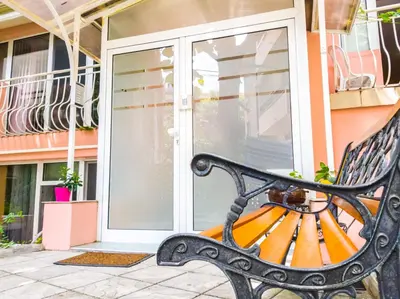 a bench sitting in front of a sliding glass door at YES Varna Studios in Varna City