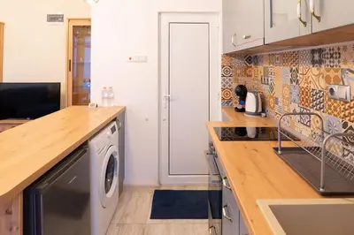 a kitchen with a washer and dryer at Seaside Estate - Cozy and Romantic - Public Parking Nearby in Varna City