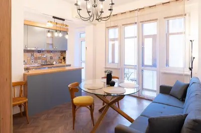 a living room with a blue couch and a table at Seaside Estate - Cozy and Romantic - Public Parking Nearby in Varna City