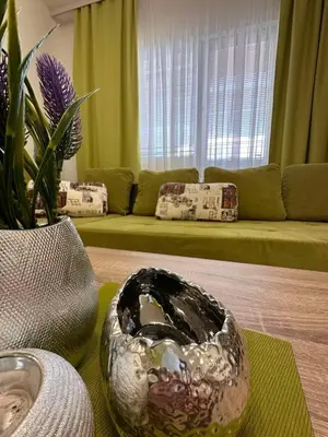 a living room with a bowl on a table at Апартамент 