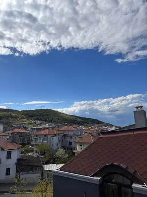 a view of a city with houses and a sky at Апартамент 