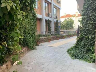 a sidewalk in front of a building with plants at Апартамент 