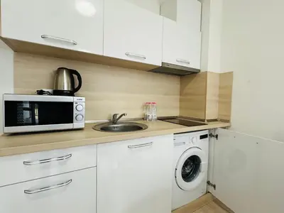 a kitchen with a sink and a microwave at HORIZON 4 'Б' Apartment Sveti Vlas in Sveti Vlas