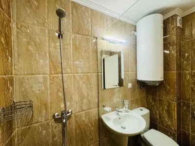 a bathroom with a sink and a toilet and a mirror at HORIZON 4 'Б' Apartment Sveti Vlas in Sveti Vlas