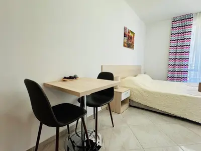 a bedroom with a desk and two chairs and a bed at HORIZON 3 'Б' Studio Sveti Vlas in Sveti Vlas
