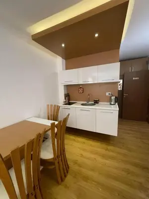 a kitchen with a table and chairs and a sink at Sweety SP apartments in Sunny Beach