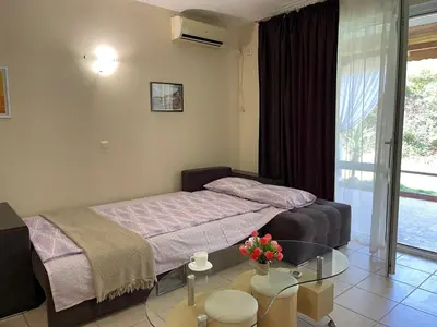 a bedroom with a bed and a glass table at Sea Salt Suite- Sozopol in Sozopol