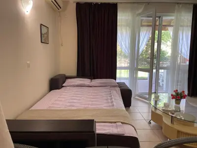 a bedroom with a large bed and a glass window at Sea Salt Suite- Sozopol in Sozopol