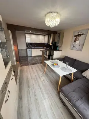 a living room with a couch and a table at Tei-Zi apartments in Burgas City