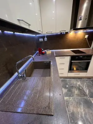 a kitchen with a counter with a sink in it at Tei-Zi apartments in Burgas City