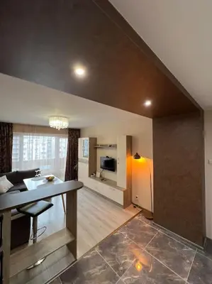 a living room with a dining table and a living room at Tei-Zi apartments in Burgas City
