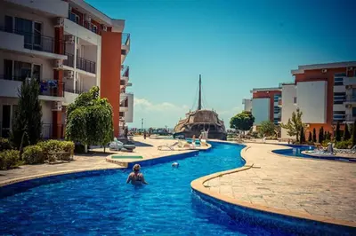 a person in a swimming pool in a city at Привилидж первая линия in Sveti Vlas
