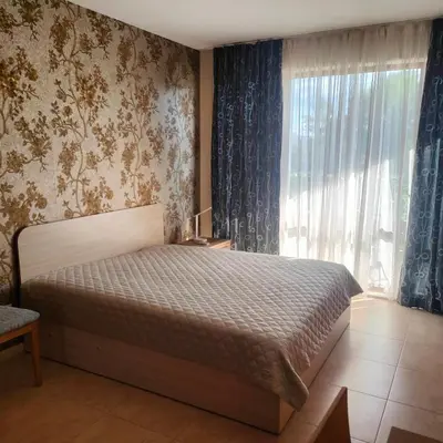 a bedroom with a bed and a large window at Delta River Park in Sunny Beach
