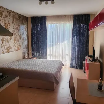 a bedroom with a bed and a large window at Delta River Park in Sunny Beach