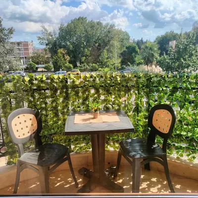 a table and two chairs sitting on a balcony at Delta River Park in Sunny Beach