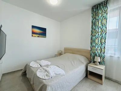 a bedroom with a bed with towels on it at HORIZON 27 'В' Studio Sveti Vlas in Sveti Vlas