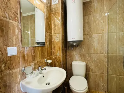 a bathroom with a sink and a toilet and a mirror at HORIZON 27 'В' Studio Sveti Vlas in Sveti Vlas
