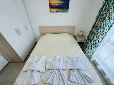 a bedroom with a bed with two pillows on it at HORIZON 26 'В' Apartment Sveti Vlas in Sveti Vlas