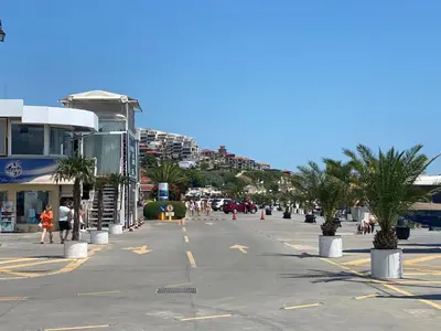 a street in a city with palm trees and buildings at HORIZON 26 'В' Apartment Sveti Vlas in Sveti Vlas