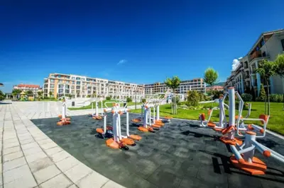 a gym with exercise equipment in a park at Premier Fort Apartment on Seafront in Sveti Vlas