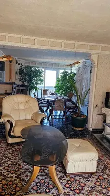 a living room with couches and a coffee table at Хоризонт in Nesebar