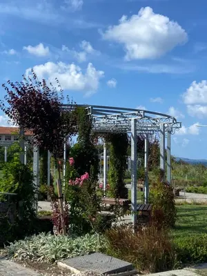 a pergola with flowers and plants in a garden at Порт Лозенец Морска Гледка - Port Lozenets Sea View in Lozenets