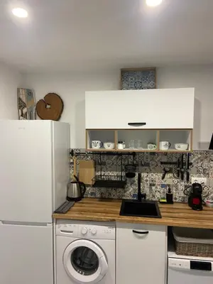 a kitchen with a white refrigerator and a washing machine at Порт Лозенец Морска Гледка - Port Lozenets Sea View in Lozenets