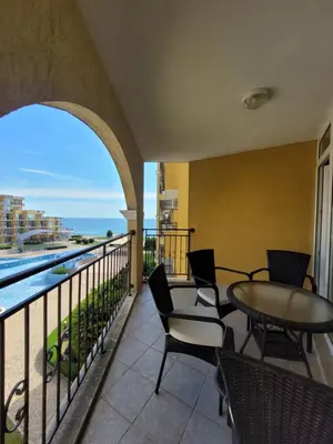 a balcony with a table and chairs and a view of the ocean at ALMA DEL MAR - Miadia Grand Resort, Aheloy in Aheloy