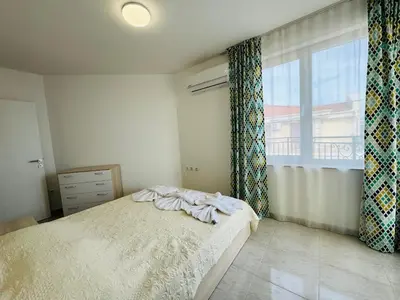 a bedroom with a bed and a large window at HORIZON 9 'В' Apartment Sveti Vlas in Sveti Vlas