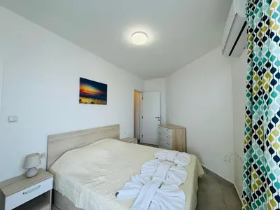 a small bedroom with a bed with white sheets at HORIZON 5 'A' Apartment Sveti Vlas in Sveti Vlas