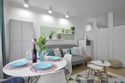 a living room with a table and a couch at Sea Moreto Studio 1 in Burgas City