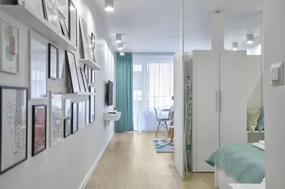 a room with a bed and some pictures on the wall at Sea Moreto Studio 1 in Burgas City