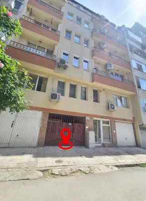 a red symbol sitting in front of a building at Downtown Apartment Varna in Varna City