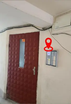 a red symbol on a wall next to a door at Downtown Apartment Varna in Varna City