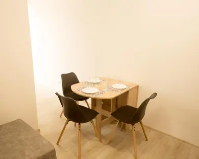 a table with two chairs and a table with glasses on it at Aleks Top Center 2- Free parking in Burgas City