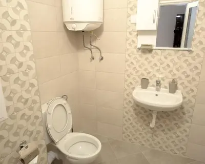 a bathroom with a toilet and a sink at Aleks Top Center 2- Free parking in Burgas City