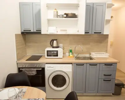 a kitchen with a washing machine and a sink at Aleks Top Center 2- Free parking in Burgas City