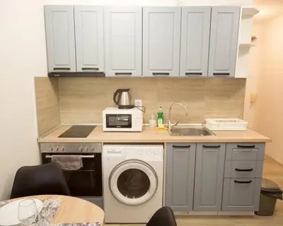 a kitchen with a washing machine and a sink at Aleks Top Center 2- Free parking in Burgas City