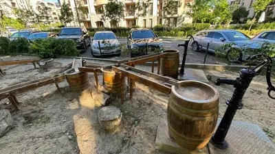 a group of wooden barrels sitting next to a parking lot at Studio/free yoga&aqua aerobic in Sunny Beach