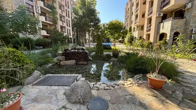 a garden with a pond in the middle of a street at Studio/free yoga&aqua aerobic in Sunny Beach