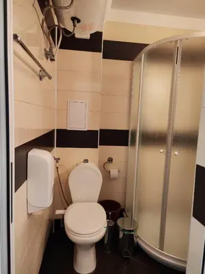 a bathroom with a toilet and a shower at Nev in Burgas City