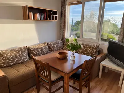 a living room with a table and a couch at Summer Rose Studio by the Sea in Byala
