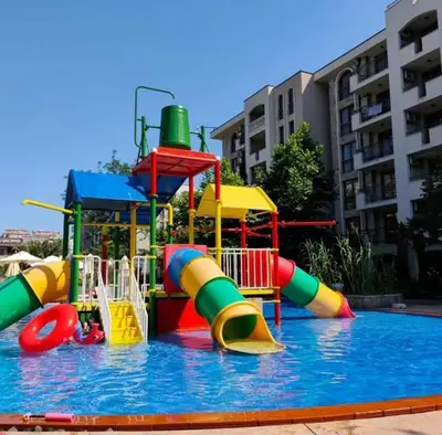 a water park with a colorful water slide at Coliber Apart Cascadas in Sunny Beach