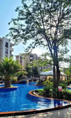 a swimming pool in a resort with trees and buildings at Coliber Apart Cascadas in Sunny Beach